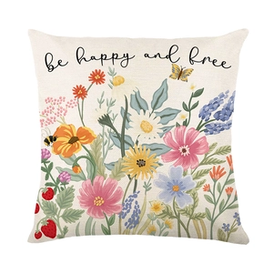 Floral print throw pillow cover with be happy and free text on linen textured fabric