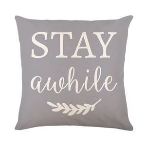 Grey floral throw pillow cover with Stay Awhile print and botanical graphics for sofa decor