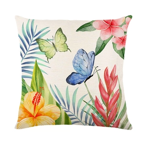 Tropical floral pillow cover with yellow hibiscus and palm leaves on linen texture