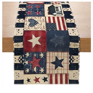 Detail of red white and blue American flag patchwork style table runner on wooden desk