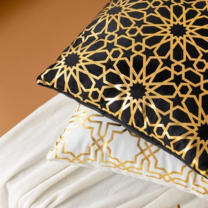 Geometric gold stamped throw pillow covers in black and white velvet for sofa decor