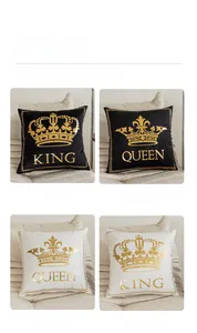 Detail of King and Queen crown prints on soft black and white plush pillow covers