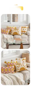 Detail of boho tufted pillow covers with tassels, sun patterns and geometric textures