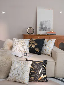 Detailed view of luxury gold foiled geometric and leaf patterns on velvet pillowcases
