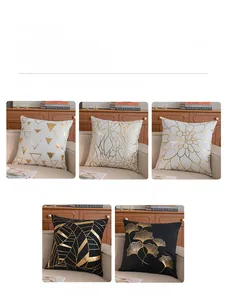 Detail of short plush cushion covers with gold foil leaves and geometric patterns