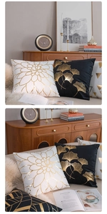 Detail of velvet pillow covers with gold foil leaves and geometric patterns on a cabinet