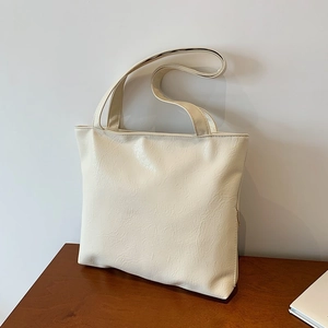 Minimalist cream white oversized faux leather tote bag with subtle wrinkled texture finish