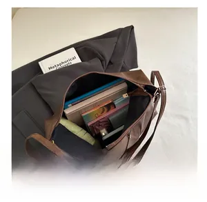 Top view of large brown leather tote bag interior showing spacious capacity and zipper