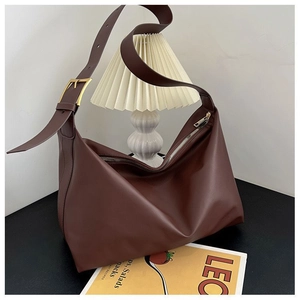 Close-up of brown PU leather hobo tote bag with golden buckle and zipper detail