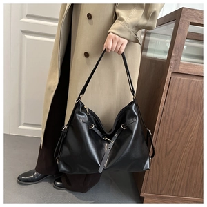 Detail of a large black vintage hobo shoulder bag with matte finish and silver hardware
