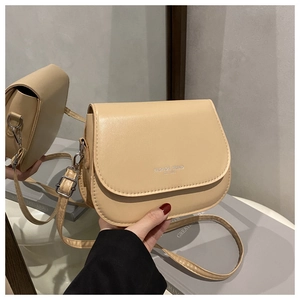 Detail of beige saddle bag showing PU leather texture and Fashion Trend lettering