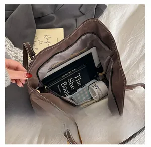Interior view showing the large capacity and pockets of the brown suede tote bag