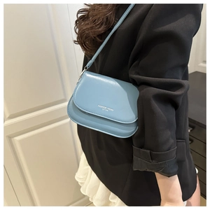 Fashionable light blue crossbody bag worn by a model to show size and styling