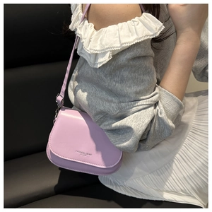 Lavender faux leather saddle bag featuring an embossed logo and slim crossbody strap