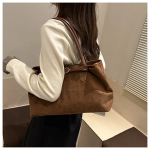Brown faux suede oversized tote bag showing natural drape and capacity on model's shoulder