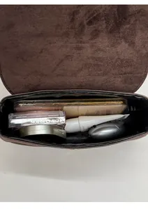 Interior view showing the storage capacity of this small brown suede shoulder bag