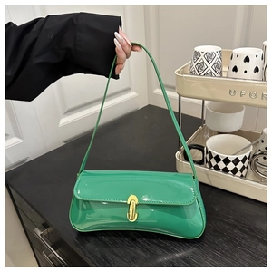 Detail of green patent leather shoulder bag with smooth finish and golden metal lock
