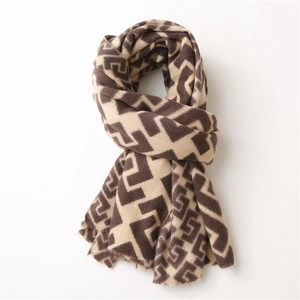 Close-up of geometric pattern on cashmere-like scarf with soft fringe detailing
