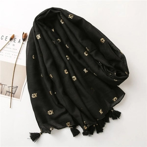 Elegant black cotton scarf with gold tiger prints and stylish fringe details