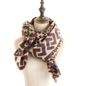 Detail of vintage geometric pattern cashmere-like scarf with soft fringe edges