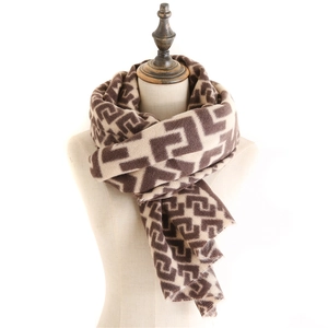 Macro detail of thick brown and beige maze geometric pattern scarf with fringe edges