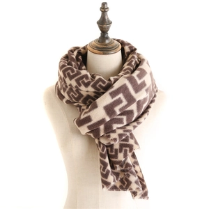 Close-up of geometric maze jacquard pattern on soft brown and beige cashmere shawl