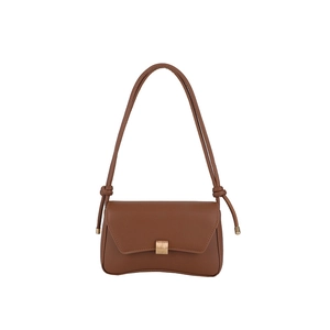 Minimalist brown curved shoulder bag with knots and metal buckle on white background