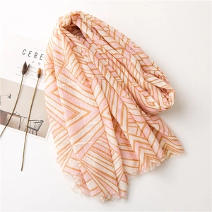 Pink and beige geometric print cotton linen scarf with fringe edges on white background
