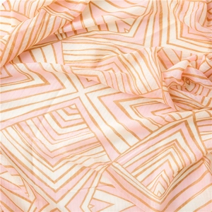 Detail view of cotton linen scarf showing geometric pattern in pink and orange