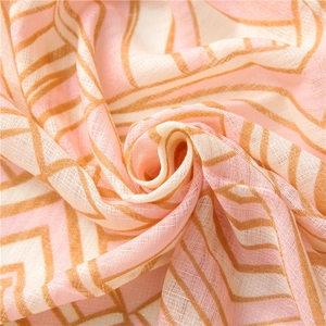 Close-up of soft pink and orange geometric striped cotton linen scarf fabric texture