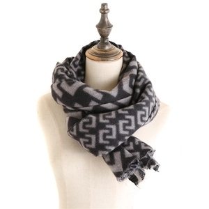Macro detail of geometric pattern and fringe on dark grey cashmere-feel scarf