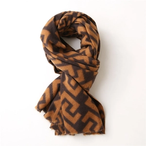 Close-up of geometric pattern and soft fringe on brown cashmere-style winter scarf