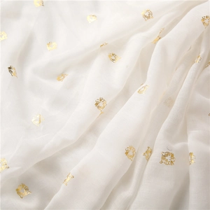 Detailed view of lightweight cotton scarf with golden tiger foil print pattern