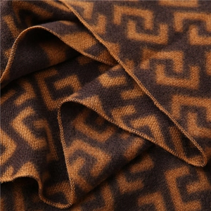 Detail showing the geometric maze pattern and soft cashmere-like texture of the scarf