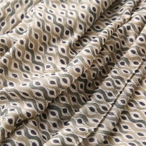 Linen feel scarf with wavy print in beige and olive green showing soft draped texture