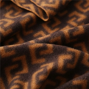 Macro shot of geometric maze pattern knit fabric showing soft cashmere texture and fiber detail