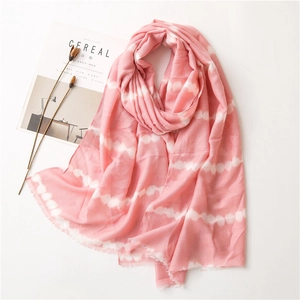 Close-up of lightweight pink tie-dye cotton linen scarf with soft fringe details