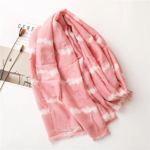 Light pink cotton linen scarf with tie-dye cloud patterns and fringed edges on white background