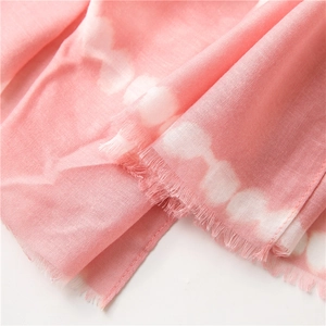 Close-up of pink and white gradient cotton linen scarf with soft fringe edges