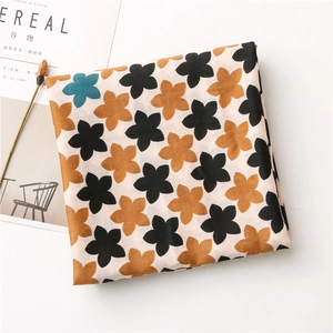Detailed flat lay of floral cotton linen scarf with elegant small flower print patterns