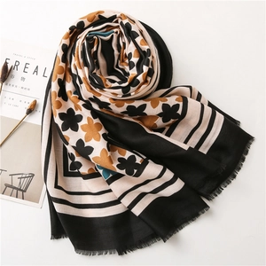 Close-up of floral print cotton linen scarf with elegant tassel fringe and vintage patterns
