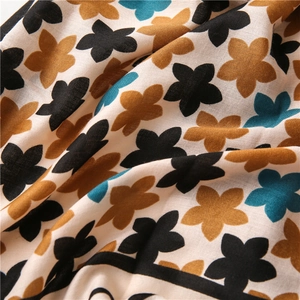 Floral cotton linen scarf featuring delicate flower prints on soft cream fabric