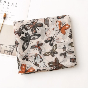 Detailed texture of cotton linen scarf with silver butterfly prints and light fabric