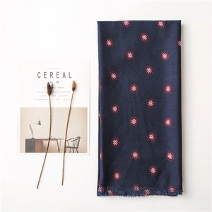 Navy blue bohemian cotton linen scarf with red floral print and tassels on white background