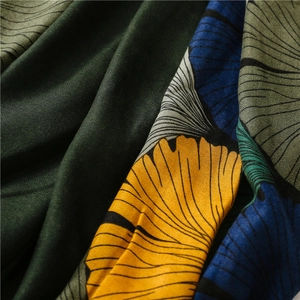 Close-up of artistic ginkgo leaf print and soft crinkled fabric texture on the scarf
