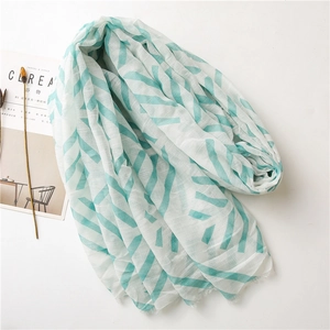 Ivory cotton linen long scarf with mint green geometric V-patterns and frayed edges