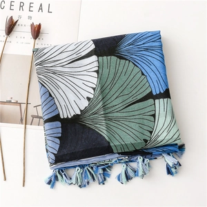 Close-up of vintage ginkgo leaf print scarf with delicate colorful fringe tassels