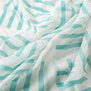 Macro view of light cotton linen scarf with mint green geometric chevron patterns