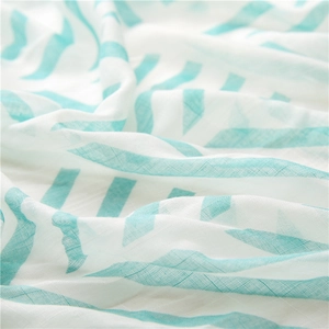 Detail of blue herringbone print on soft, breathable white cotton linen scarf fabric