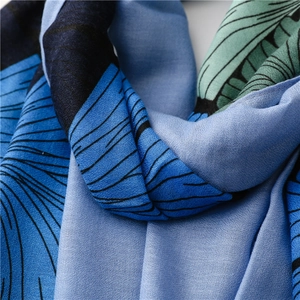 Close-up of vintage ginkgo print scarf showing smooth drape and silk texture detail